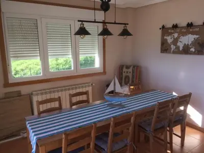 a dining room with a blue and white table and chairs at CASA FONTE DA PEDREIRA in Sada