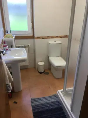 a bathroom with a toilet and a sink at CASA FONTE DA PEDREIRA in Sada