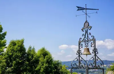 a bell with a weather vane on top of it at Pazo do Rio in A Coruña