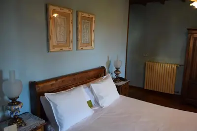 a bedroom with a bed with white sheets and pillows at Pazo do Rio in A Coruña