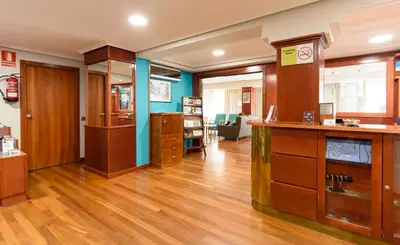a large room with wooden floors and wooden cabinets at México PR in Santiago de Compostela