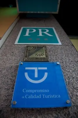 a blue sign on a counter with the text compendium at México PR in Santiago de Compostela