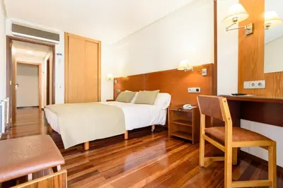 a bedroom with a bed and a desk and a chair at México PR in Santiago de Compostela