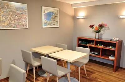 a room with two tables and chairs and a book shelf at México PR in Santiago de Compostela