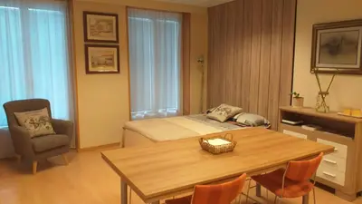 a bedroom with a bed and a table and chairs at Loft Plaza Mayor in Ourense