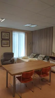 a living room with a table and chairs and a couch at Loft Plaza Mayor in Ourense