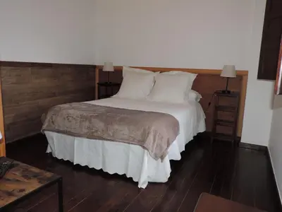 a bedroom with a large bed with white sheets and pillows at El Rincón Maragato in Castrillo De Los Polvazares