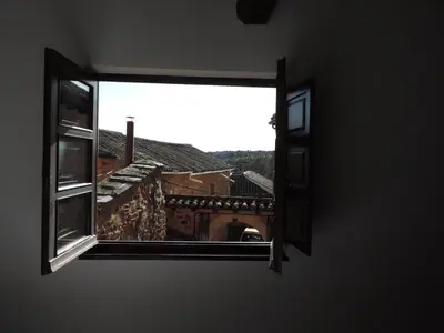 a window in a room with a view of a bridge at El Rincón Maragato in Castrillo De Los Polvazares