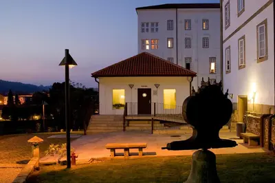 a building with a bench in front of a building at San Francisco Hotel Monumento in Santiago de Compostela