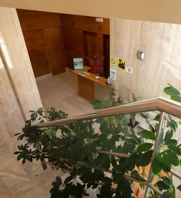 a staircase leading to a lobby with a desk at Apartamentos Ciudad de Lugo in Lugo