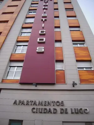a building with a sign on the side of it at Apartamentos Ciudad de Lugo in Lugo