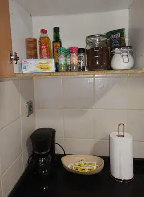 a kitchen with a counter with a shelf with spices at Antolín Yellow Door in Ponferrada