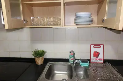 a kitchen counter with a sink and plates on the wall at Antolín Yellow Door in Ponferrada