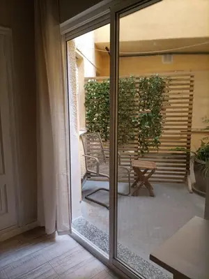 a sliding glass door with a chair on a patio at Hostal Quiper in Quiroga
