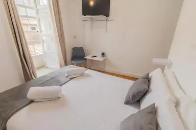 an open window with a view of a city at Hostal San Pelayo in Santiago de Compostela