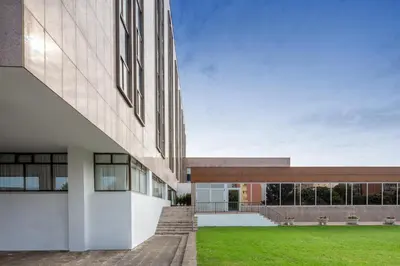 an external view of a building with a grass yard at Eurostars Gran Hotel Lugo in Lugo