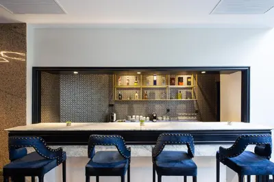 a bar with blue chairs and a counter at Eurostars Gran Hotel Lugo in Lugo