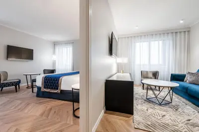 a hotel room with a bed and a living room at Eurostars Gran Hotel Lugo in Lugo
