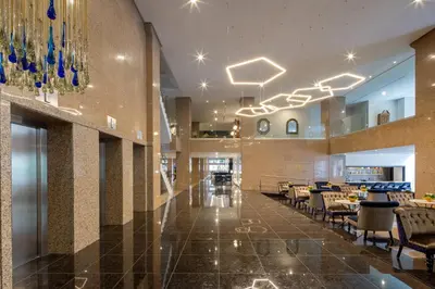 a lobby with chairs and tables in a building at Eurostars Gran Hotel Lugo in Lugo