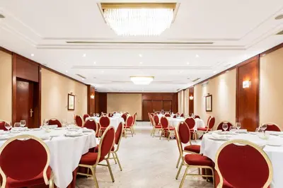 a conference room with white tables and chairs at Eurostars Gran Hotel Santiago in Santiago de Compostela