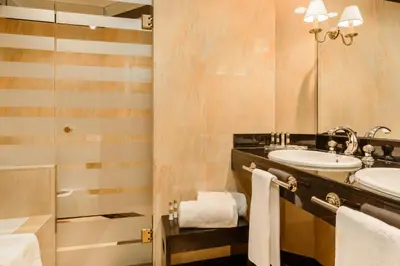 a bathroom with two sinks and a mirror at Eurostars Gran Hotel Santiago in Santiago de Compostela