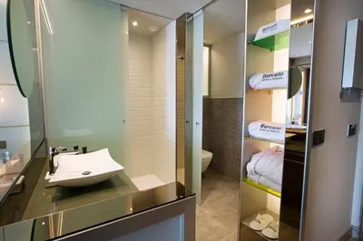 a bathroom with a sink and a mirror at Barceló Ourense in Ourense