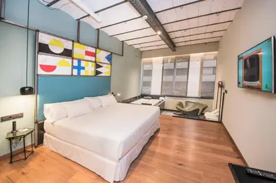 a bedroom with a large white bed in a room at Barceló Ourense in Ourense