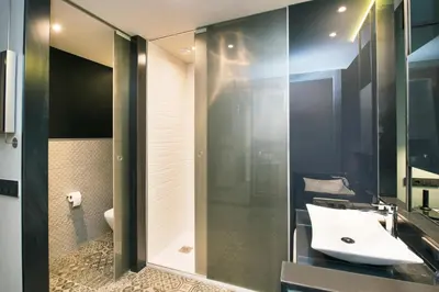 a bathroom with a sink and a mirror at Barceló Ourense in Ourense