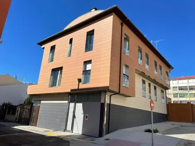 a building on a street corner with at El Roble 9 in Astorga