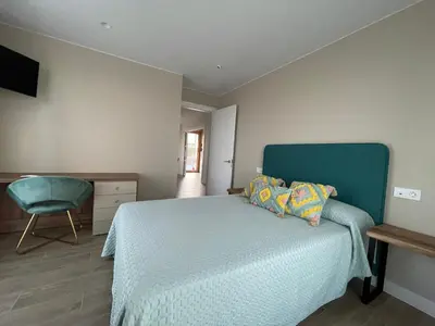 a bedroom with a bed and a chair in it at El Roble 9 in Astorga