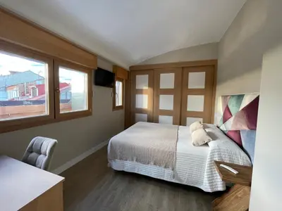 a bedroom with a bed and a window at El Roble 9 in Astorga