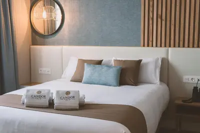 a large white bed with two pillows on it at HOTEL CANDOR in A Lama