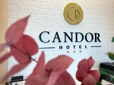 a sign for a canadian hotel with red flowers at HOTEL CANDOR in A Lama