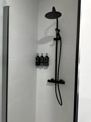 a shower with a glass door with two bottles at Casa Amodiño in Belesar