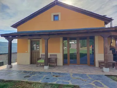 a house with a large deck with glass doors at Casa Antonio in Susañe del Sil