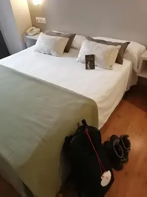 a black bag sitting on a bed in a room at Duerming Villa De Sarria Hotel in Sarria