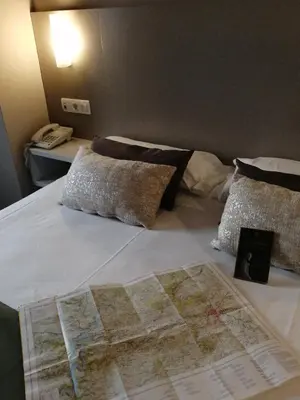 a large white bed with a map on it at Duerming Villa De Sarria Hotel in Sarria