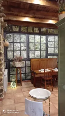 a room with a table and chairs and a table and windows at Casa el rey 12 - Apartamentos Buenos Aires y Figueras AR-1419-AS in Valbona