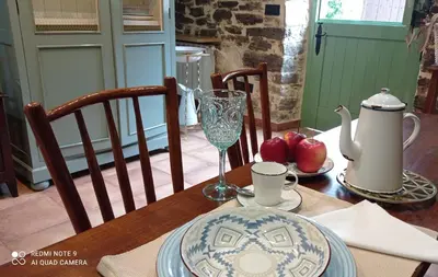 a table with a plate of food and a glass at Casa el rey 12 - Apartamentos Buenos Aires y Figueras AR-1419-AS in Valbona