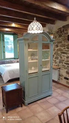 a blue cabinet in a room with a bed at Casa el rey 12 - Apartamentos Buenos Aires y Figueras AR-1419-AS in Valbona