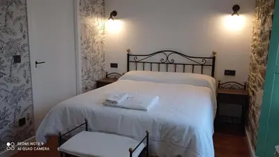 a bedroom with a bed with two towels on it at Casa el rey 12 - Apartamentos Buenos Aires y Figueras AR-1419-AS in Valbona