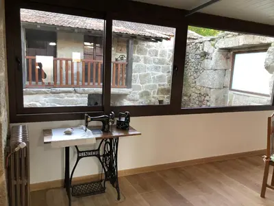 a bathroom with a sink and two windows at Casa Lisboana in Pontevedra