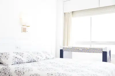 a bedroom with a bed and a window at Rey Fernando in Santiago de Compostela