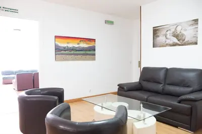 a living room with two chairs and a glass table at Rey Fernando in Santiago de Compostela