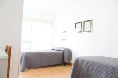 a bedroom with two beds and a window at Rey Fernando in Santiago de Compostela