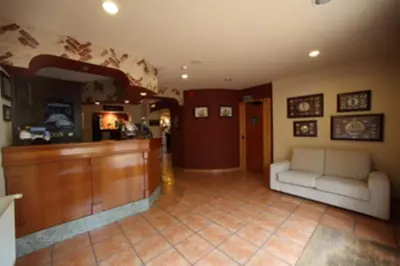 a living room with a couch and a counter at Hotel El Pescador in Perillo
