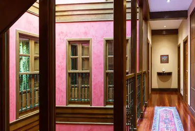 a room with a pink wall and windows at Hotel Rua Villar in Santiago de Compostela