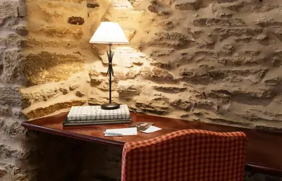 a desk with a lamp and a keyboard on it at Hotel Rua Villar in Santiago de Compostela