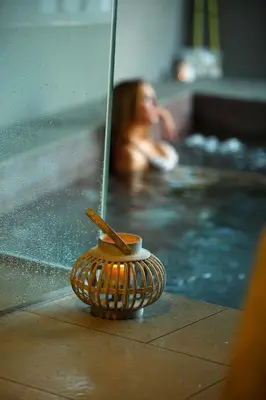 a woman in a swimming pool with a jacuzzi at Apartamentos Las Sirenas in Viveiro