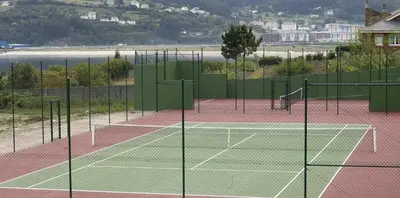 a tennis court with two tennis nets on it at Apartamentos Las Sirenas in Viveiro